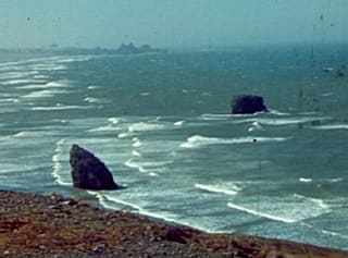Waves around sea stacks off a rocky coast