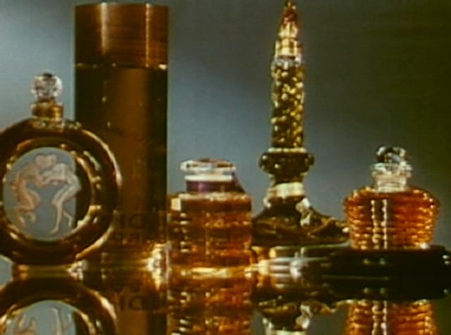 Amber perfume bottles glowing under warm light