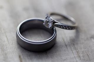 Two wedding rings on a wooden table
