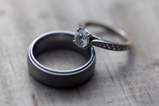 Two wedding rings on a wooden table