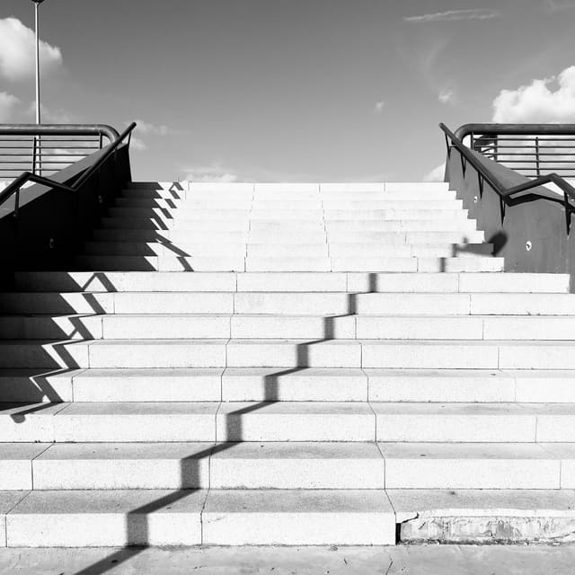 White steps striped with hard shadows