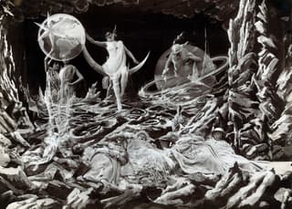 Painted planets and stars as figures above sleeping explorers, from A Trip to the Moon
