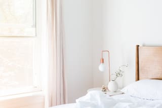 A white bedroom in soft window light